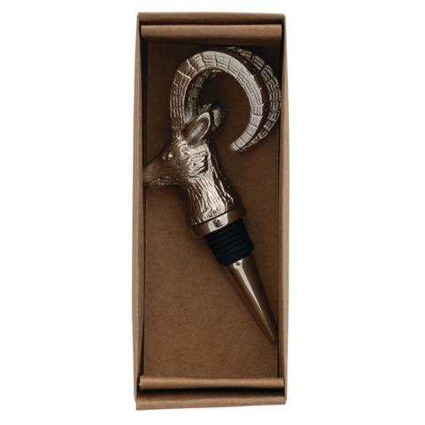 Decorative wine bottle stopper with ram design in a brown box on a white background