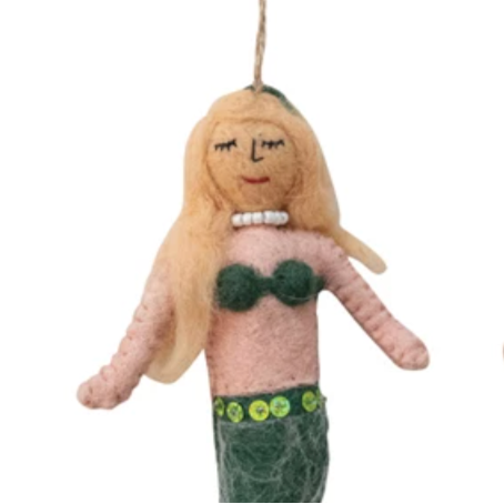 Mermaid doll with blonde hair and green tail on a white background