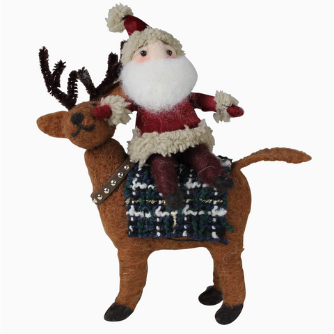 Decorative figure of Santa Claus riding a reindeer on a white background