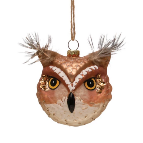 Decorative owl ornament with feathers on a white background