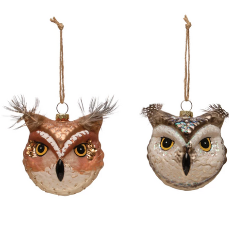 Two owl-shaped ornaments with feather details on a white background