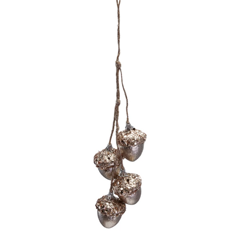 Decorative acorn ornament with a textured finish hanging on a white background