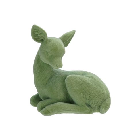 Green plush deer toy on a white background