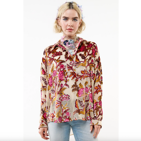 Woman wearing a floral blouse on a white background