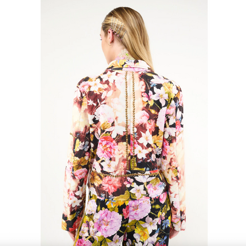 Woman wearing a floral kimono-style garment on a white background