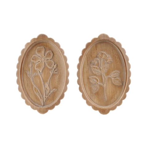 Pair of wooden earrings with floral designs on a white background