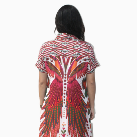 Woman wearing a colorful patterned dress on a white background