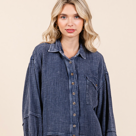 Woman wearing a blue plaid shirt against a beige background