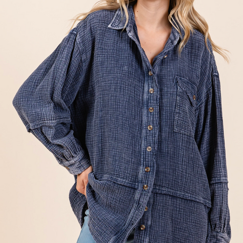 Woman wearing a blue plaid shirt with a beige background