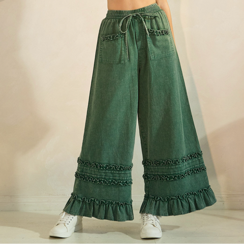 Green wide-leg pants with ruffled hem on a neutral background