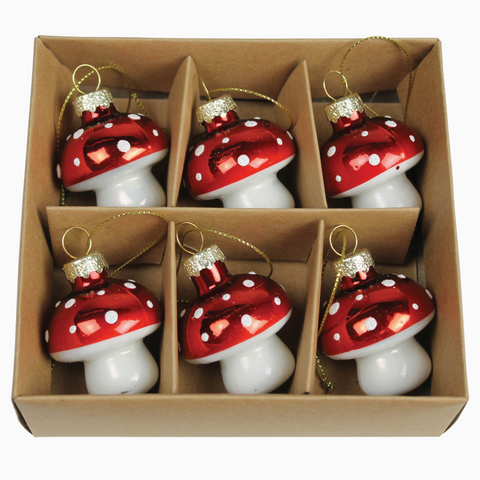 Set of red and white mushroom-shaped ornaments in a cardboard box
