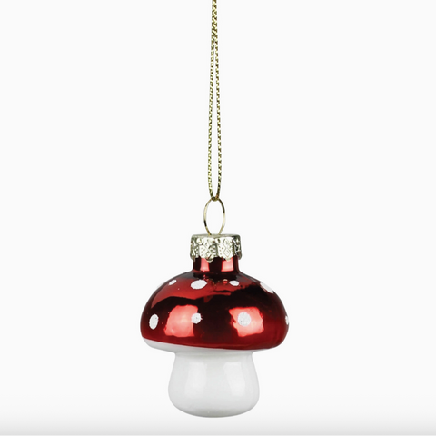 Decorative mushroom-shaped ornament with red top and white base on a white background