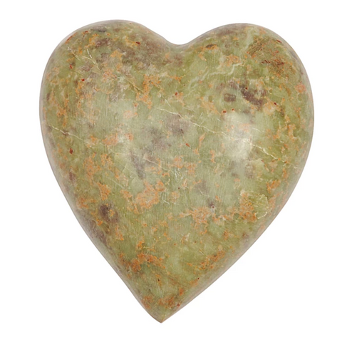 Heart-shaped green stone on a white background