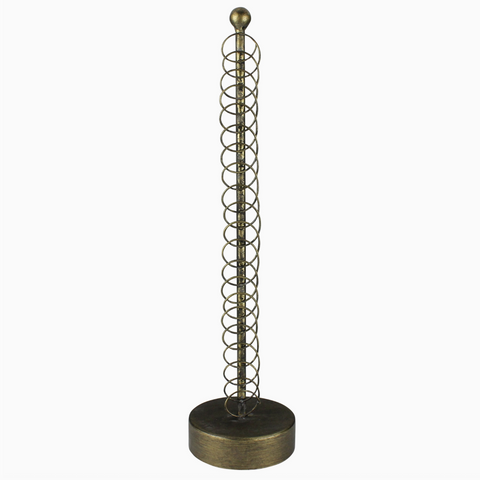 Decorative metal sculpture with spiral design on a white background