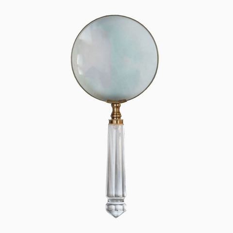 Magnifying glass with a decorative handle on a white background