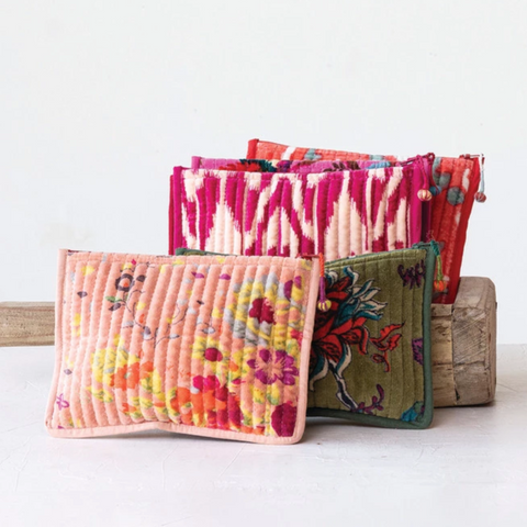 Colorful fabric pouches on a white background