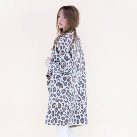 Person wearing a leopard print coat on a white background