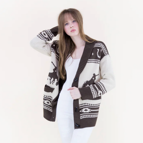 Woman wearing a patterned cardigan on a white background