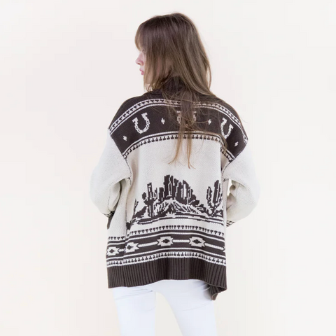 Person wearing a patterned sweater with a white background