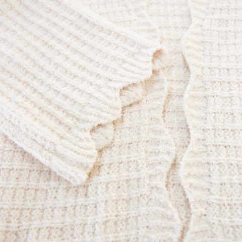 Close-up of a textured beige fabric with a subtle pattern