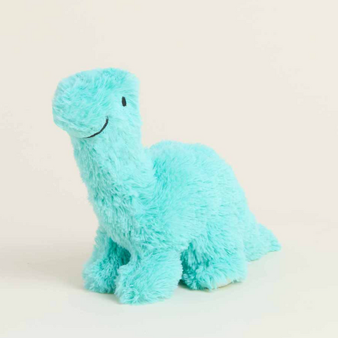Plush dinosaur toy in light blue on a beige background