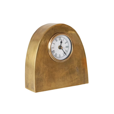 Gold-framed clock with white face on a white background
